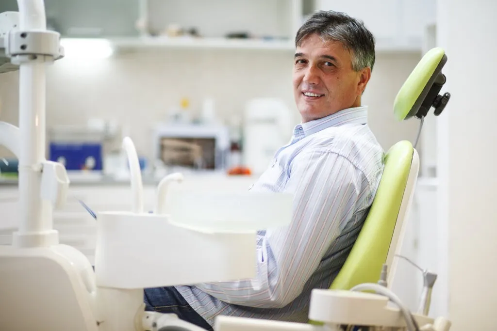 Senior male patient on dental chair waiting for the treatment.