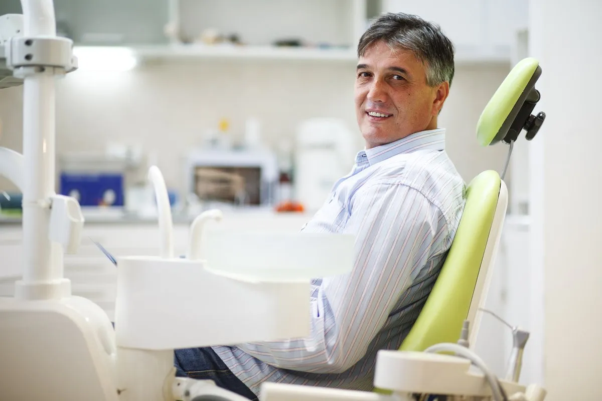 Senior male patient on dental chair waiting for the treatment.