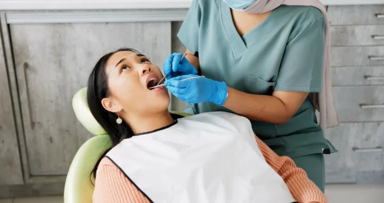 Woman, dentist and patient with clinic tools for cleaning mouth, oral or gum in dental care. Face of Asian or female person in relax with orthodontist for tooth whitening, hygiene or removing cavity.