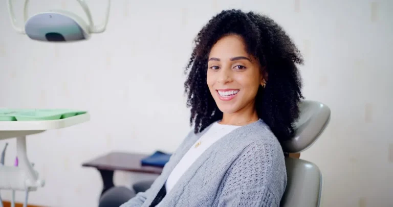 Portrait, woman and smile for dental care, clinic and confident for medical procedure or appointment. Happy, patient and oral health for person, healthcare and tooth extraction services in office