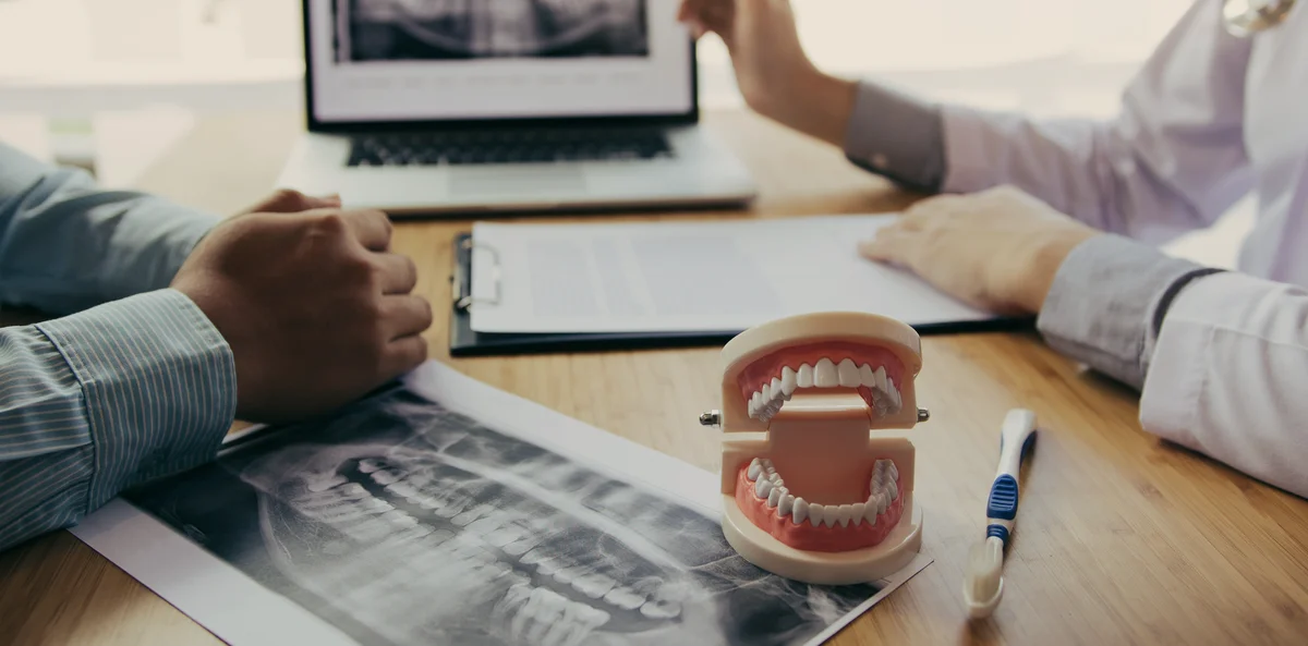 Dentist discussing dental implant results with a patient at Red Rock Dental